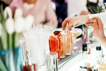 bar counter with cocktails. fruit on the table. alcoholic drinks