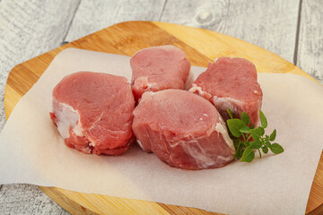 Raw pork medallion served rosemary