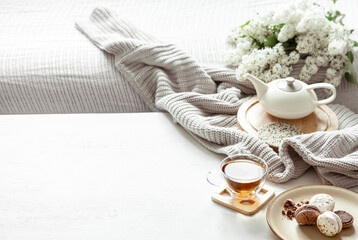 Cozy spring composition with tea and blooming lilac.