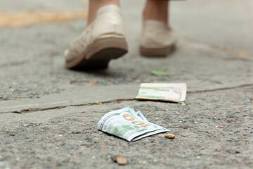 woman and money on the ground