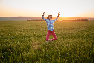 portrait of a teenage girl in a field at sunset