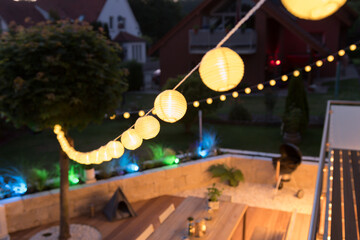 Fairy lights with lanterns over a stylish terrace