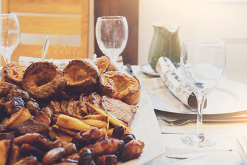 Mixed Sunday lunch, homemade roast beef with gravy, roast potato and Yorkshire pudding. Traditional British dinner, Christmas lunch ideas for party with family or friends in Christmas’s day