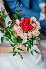 A wedding bouquet of white and red roses