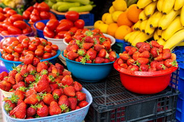 Lots of ripe red strawberries close up for sale. Showcase of the retail market for vegetables and fruits.