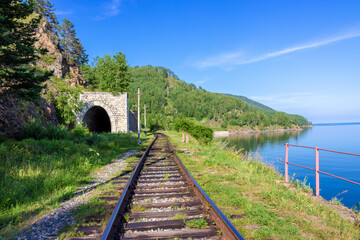 Stone arch tunnel in mountain on the Circum-Baikal railway. Summer landscape for travel in...