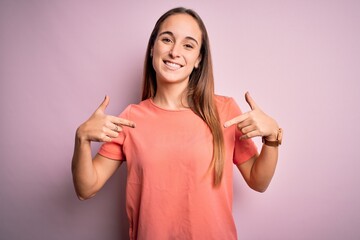 Young beautiful woman wearing casual t-shirt standing over isolated pink background looking...