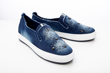 casual denim shoes isolated on a white background, denim sneakers close-up
