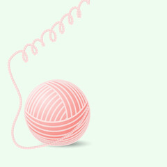 ball of woolen thread on a green background