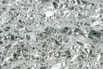 Surface texture of crumpled aluminum silver foil. Copy, empty space for text