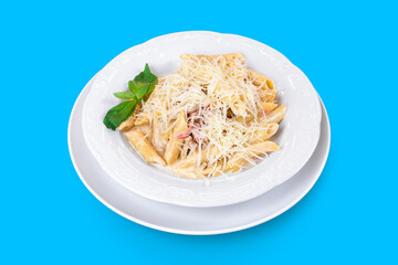 Delicious Italian penne pasta with cheese and pepper and fresh mint on blue background