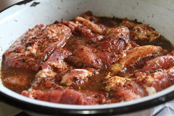 marinated pork meat on the ribs with spices Provencal herbs for frying