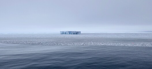 Edge of pack ice in antarctic ocean with large iceberg, Antarctica © HWL Photos