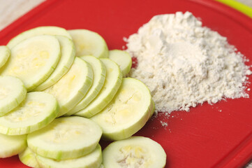 zucchini cut into circles with flour