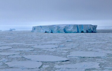 Large iceberg at edge of pack ice in antarctic ocean, Antarctica