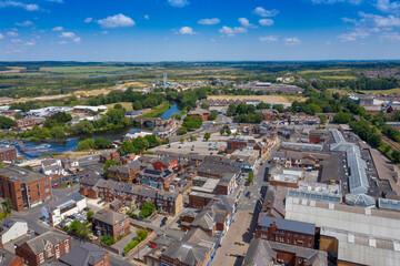 Fototapeta na wymiar Aerial photo of the village centre of Castleford in Wakefield, West Yorkshire, England showing the main street along side the River Aire on a bright sunny summers day