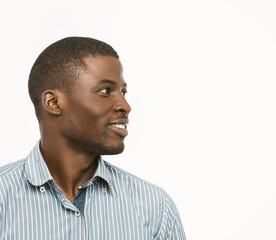 Closeup profile of handsome Afro-American man smiling isolated on white background while posing in...