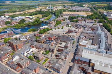 Aerial photo of the village centre of Castleford in Wakefield, West Yorkshire, England showing the main street along side the River Aire on a bright sunny summers day
