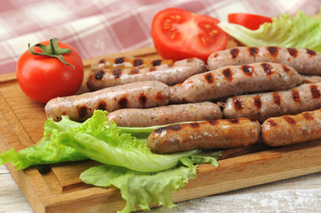 grilled smoked sausages, lettuce leaves, tomatoes