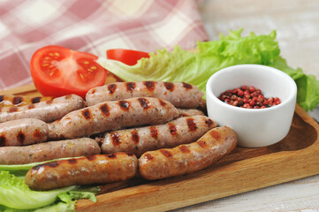 grilled smoked sausages, lettuce leaves, tomatoes
