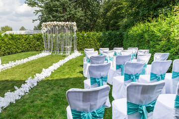 
Location for an outdoor wedding ceremony in the country in mint colors in the warm season in the daytime.