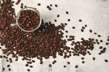 coffee beans in a transparent glass mug on a background of coffee beans