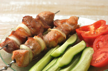 cooked pork skewer on skewers - with onions