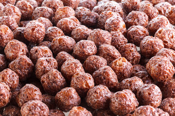 Chocolate corn balls isolated on white background. Chocolate balls dry breakfast scattered on a white background. Space for text. Also known as Chocolate flakes. Full depth of field.