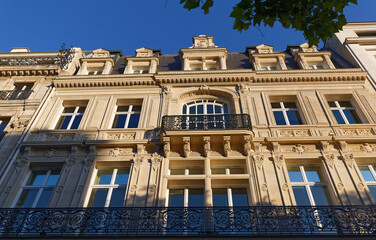 Traditional French house with typical balconies and windows. Paris.