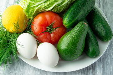 Avocado salad ingredients on a white plate.