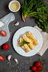 Caneloni pasta with spinach and ricotta, with bechamel sauce. 