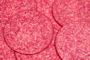 Tasty salami slices background.
