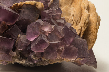 purple fluorite crystals in the foreground on light matrix