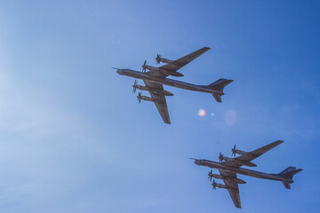 two bombers airplane in the blue sunny sky