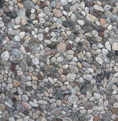 Pebble walkway background. Small round stones laid in cement mortar. Track in the park texture.