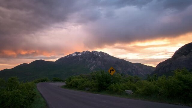 Sunrise time lapse looking at mountain and colorful clouds down road towards Provo Canyon and Timpanogos.