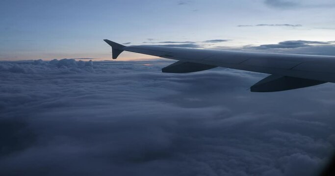 View from plane window in dark evening mist