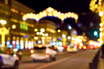 Fototapeta na wymiar Blurred abstract bokeh background of Saint Petersburg golden lights on Nevsky Prospect in New Year night