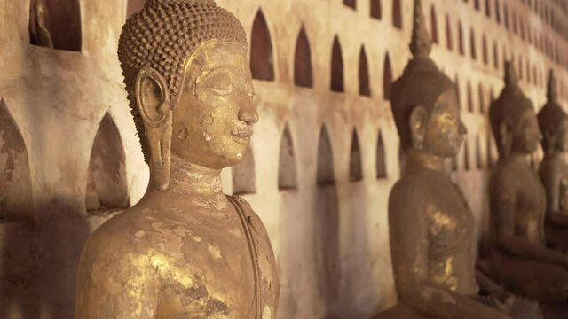 Close-up of weathered Buddha statues against wall at famous Buddhist temple museum - Vientiane, Laos