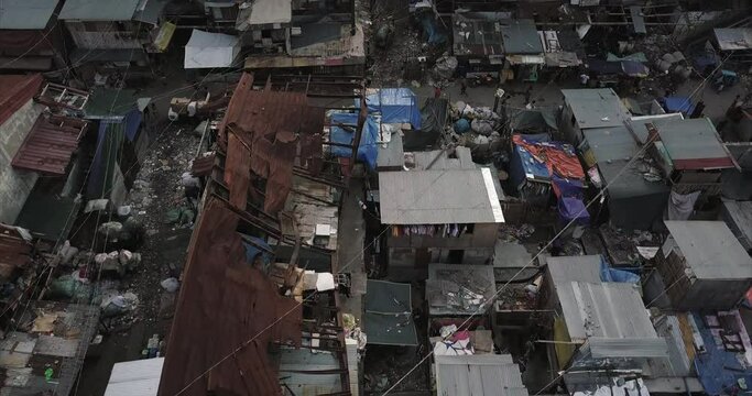 Bird's eye view aerial flight over burned house in poor housing area. Drone, 4K.