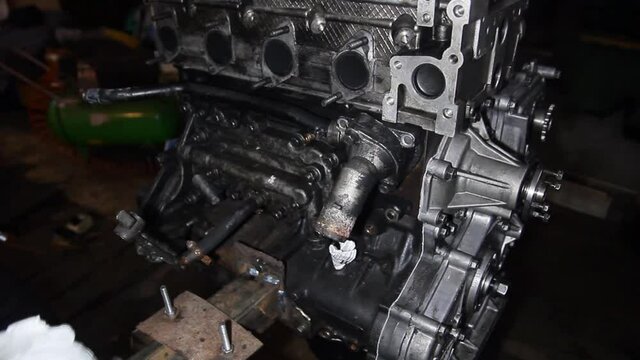 disassembled large diesel in-line diesel engine of an SUV in a garage, repair.
