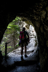 Woman On Hiking Trail Leaves A Cave In Ötschergräben In Austria