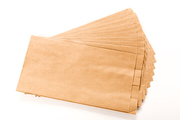 New brown craft paper bags fan-shaped on a white background. Packaging for goods, food, letters.