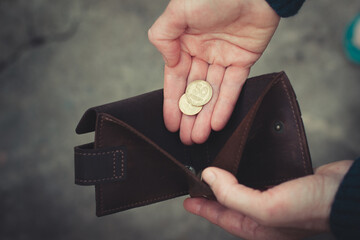 hand holds a wallet with money fired from work poverty hopelessness