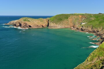 Plemont Bay, Jersey, U.K. Beautiful coastline with a high tide in the Summer.