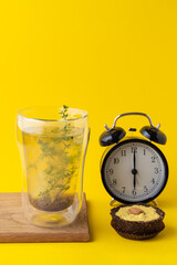 Conceptual food photo of healthy snacks on minimalist bright yellow background: vegan lemon pie and herbal tea