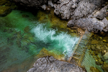 Clear Mountain River Flows Over Dam Between Rocks