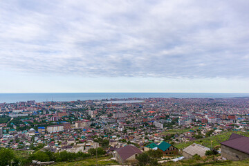 Overview of the seaside town from the mountain with cloudy sky background.