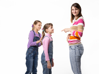 Fototapeta premium The girl begs the toy from her mother, mother wearily points a finger at the child