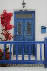 blue door with flowers in greece